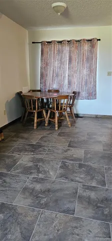 a view of a chairs and table in kitchen