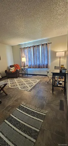 a view of a livingroom with furniture and lounge chair