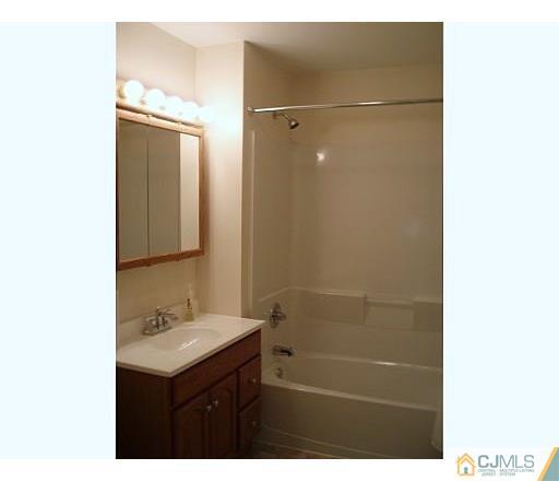 31 Brookside Road Spotswood, NJ 08884 - Photo 2 of 11 a bathroom with a sink mirror and shower