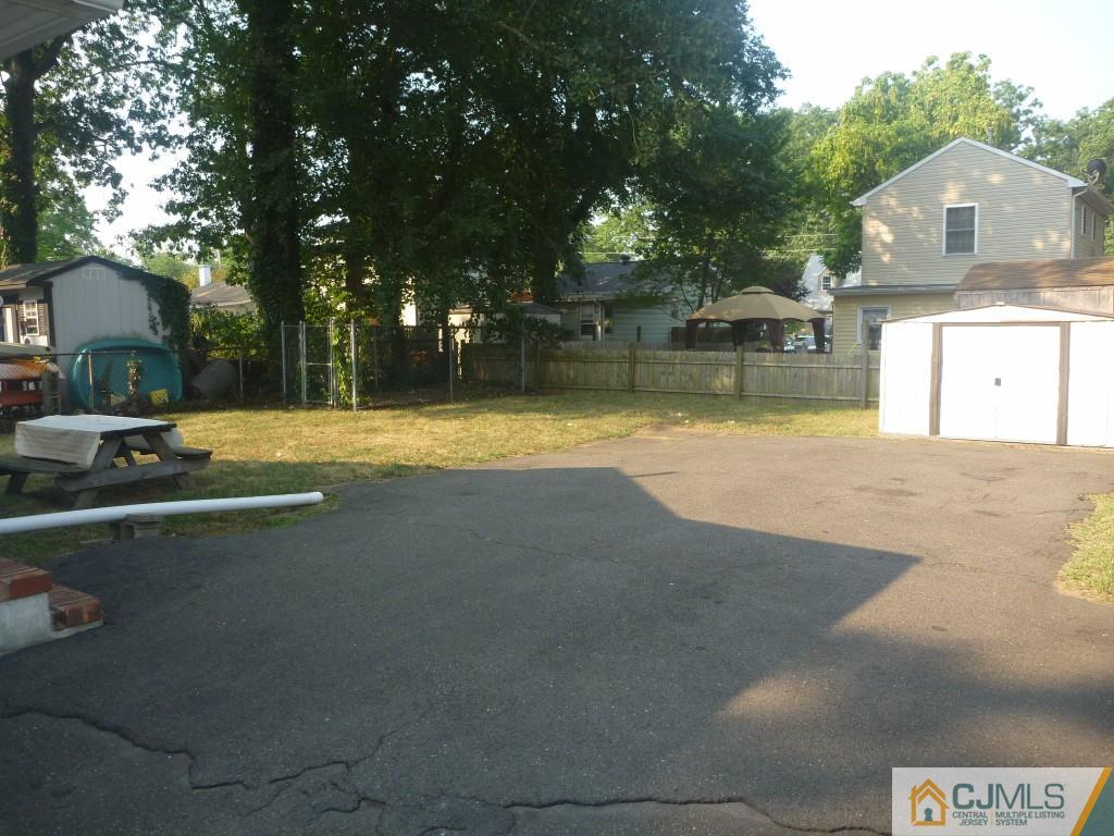31 Brookside Road Spotswood, NJ 08884 - Photo 11 of 11 a view of a house with pool and a yard