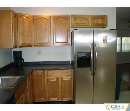 31 Brookside Road Spotswood, NJ 08884 - Photo 3 of 11 a kitchen with stainless steel appliances granite countertop a refrigerator and a sink