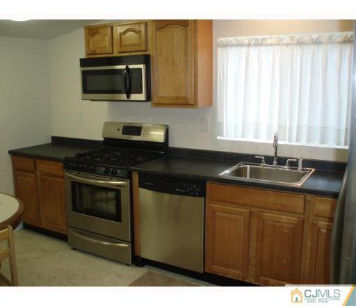 31 Brookside Road Spotswood, NJ 08884 - Photo 4 of 11 a kitchen with granite countertop a sink and a stove
