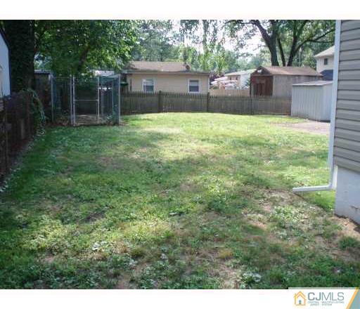 31 Brookside Road Spotswood, NJ 08884 - Photo 5 of 11 a house with trees in front of it