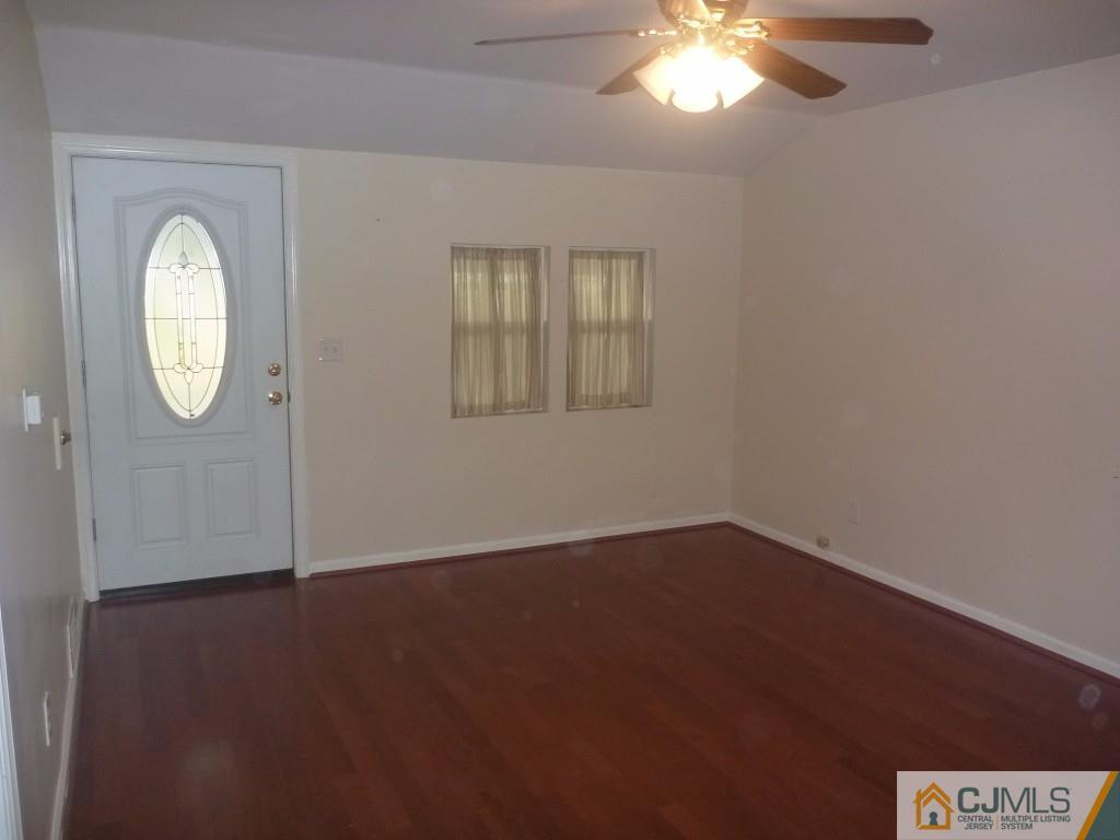 31 Brookside Road Spotswood, NJ 08884 - Photo 7 of 11 an empty room with a mirror and a window