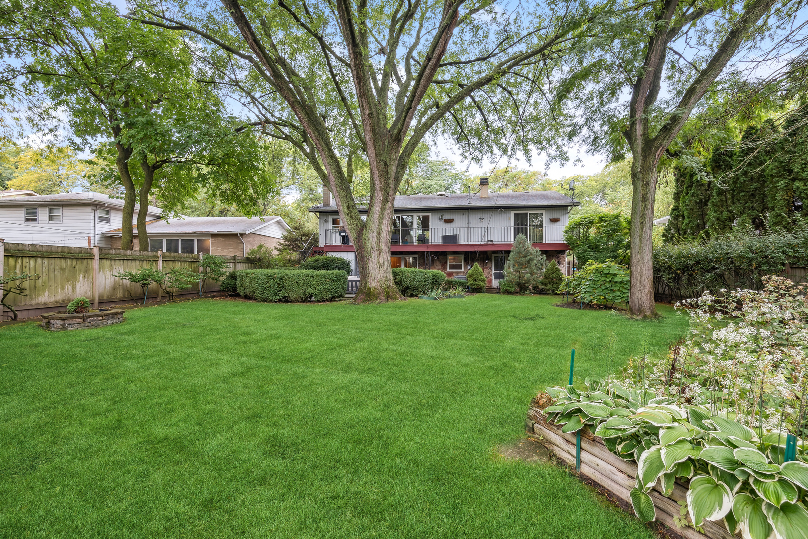430 Sandy Lane Wilmette, IL 60091 - Photo 4 of 6 a view of a backyard with table and chairs and a large tree