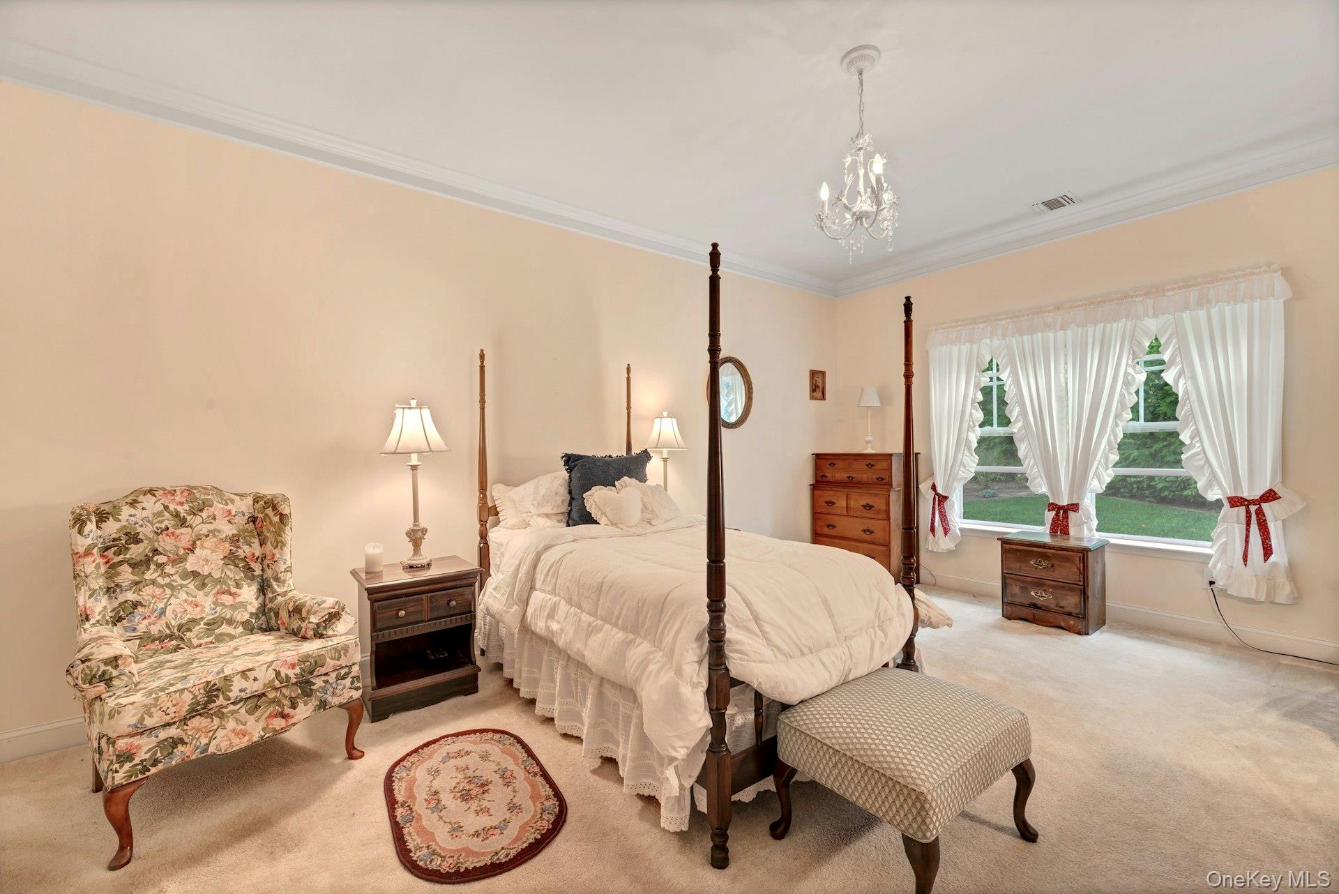 159 Stoneleigh Drive Riverhead, NY 11901 - Photo 19 of 24 Carpeted bedroom featuring ornamental molding and a chandelier
