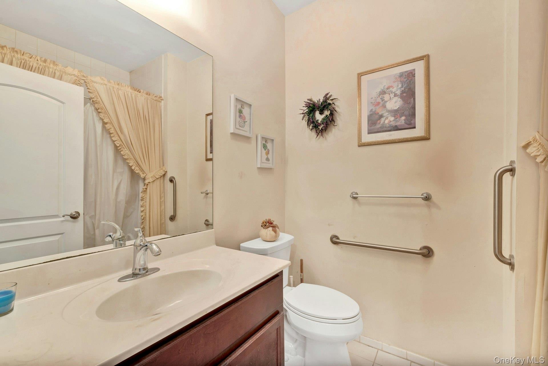 159 Stoneleigh Drive Riverhead, NY 11901 - Photo 23 of 24 Full bath with vanity, light tile patterned flooring, and a shower with curtain