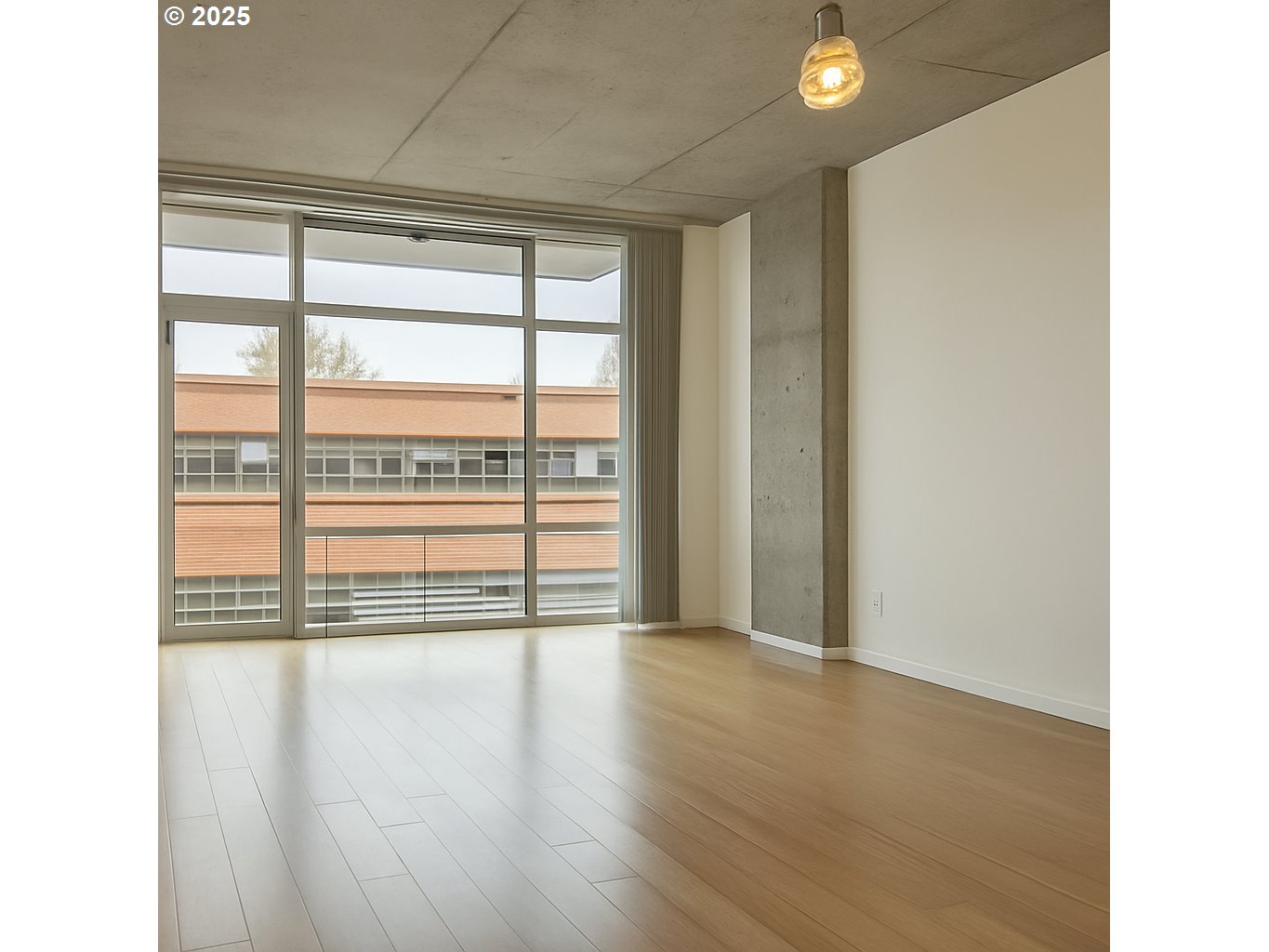 1234 Southwest 18th Avenue, Unit 301 Portland, OR 97205 - Photo 3 of 14 a view of an empty room with wooden floor and a window