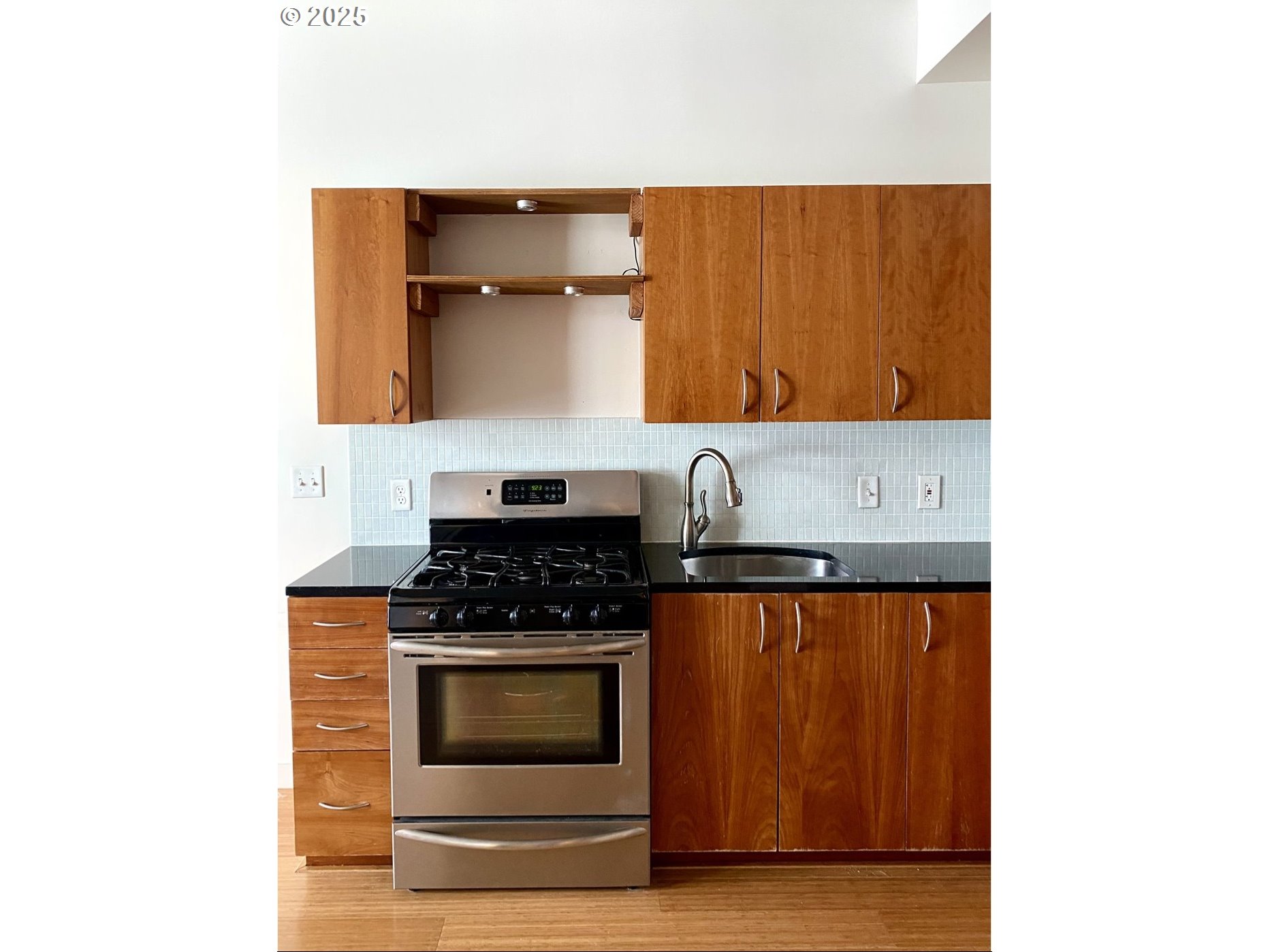 1234 Southwest 18th Avenue, Unit 301 Portland, OR 97205 - Photo 6 of 14 a kitchen with granite countertop a stove and a microwave