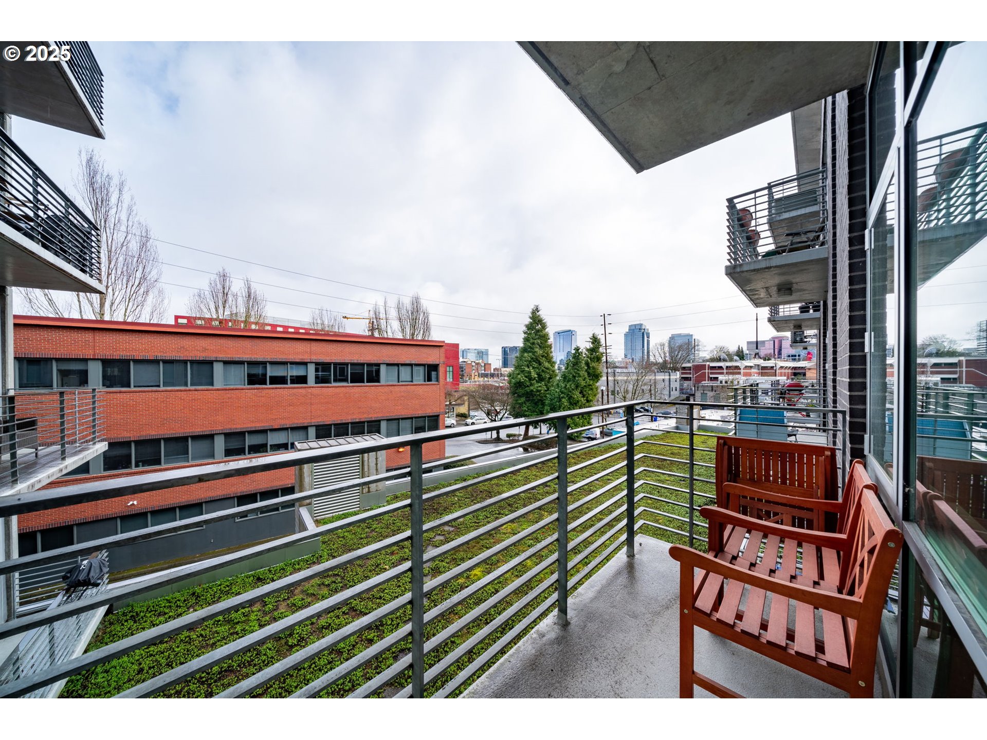 1234 Southwest 18th Avenue, Unit 301 Portland, OR 97205 - Photo 7 of 14 a view of a balcony with wooden benches
