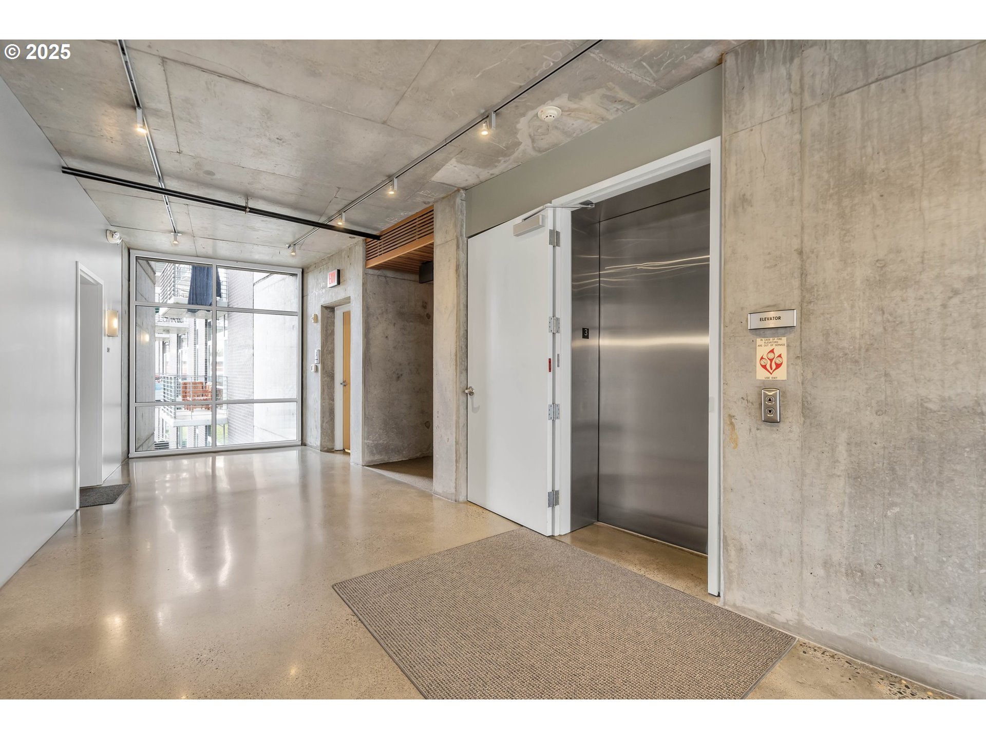 1234 Southwest 18th Avenue, Unit 301 Portland, OR 97205 - Photo 10 of 14 a view interior of a house wooden floor and windows in a room