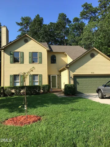 a view of a yard in front view of a house