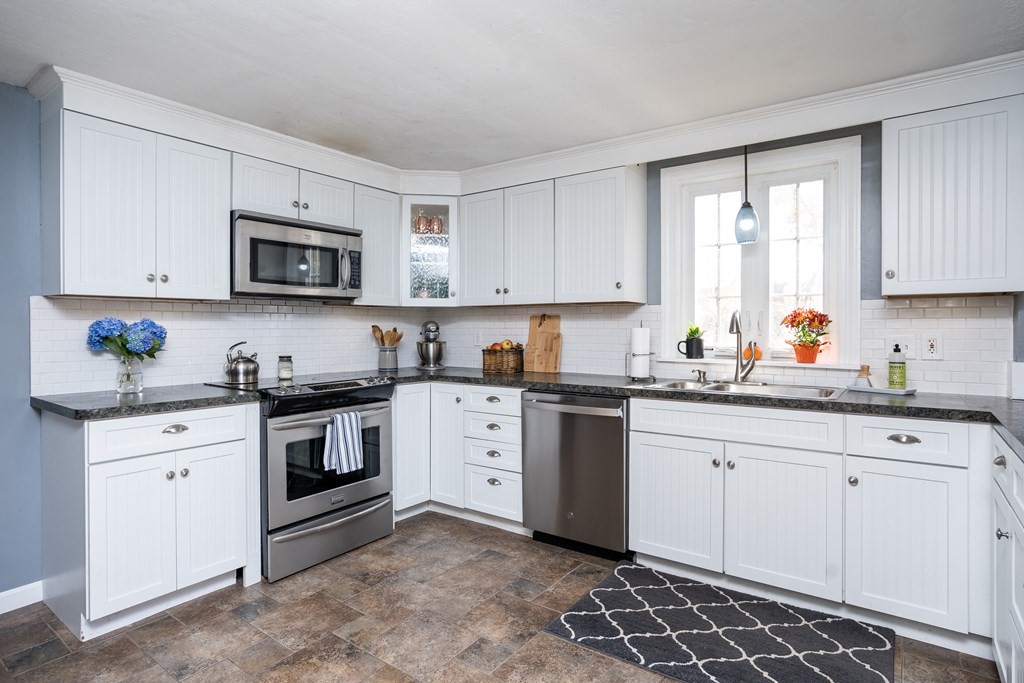 120 Stebbins Road Monson, MA 01057 - Photo 25 of 41 a kitchen with granite countertop white cabinets sink and stainless steel appliances