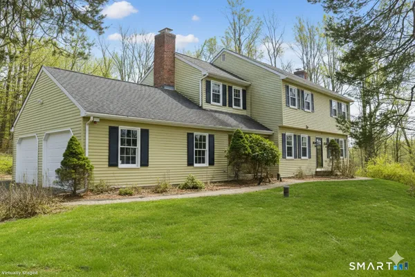 a front view of house and yard with green space