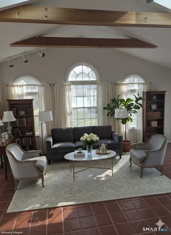a living room with furniture and a large window