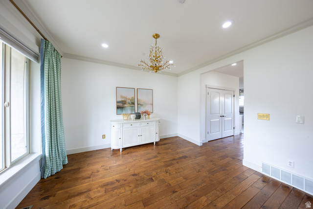 868 Braddock Lane Alpine, UT 84004 - Photo 12 of 64 Spacious room featuring wood-finish flooring, a contemporary chandelier, recessed ceiling lighting, crown molding, and white baseboards