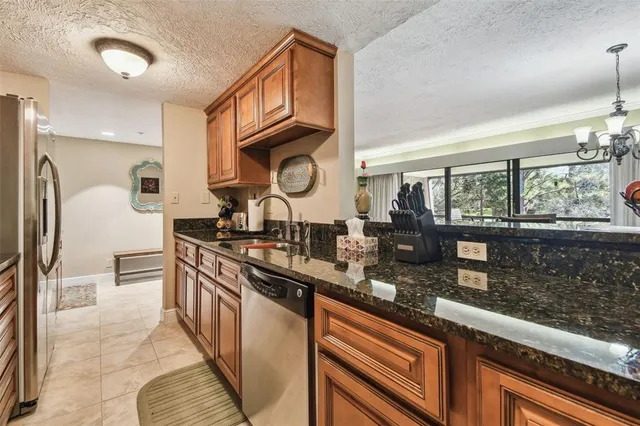 a kitchen with stainless steel appliances granite countertop a stove and a sink