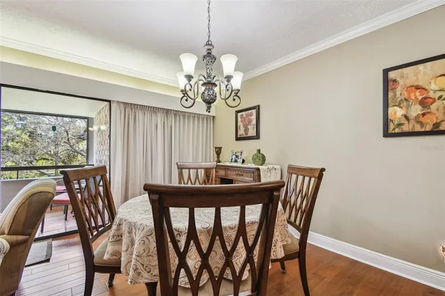 a view of a dining room with furniture and chandelier