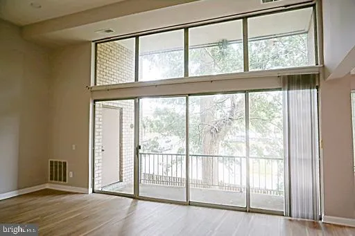 a view of an entryway with wooden floor