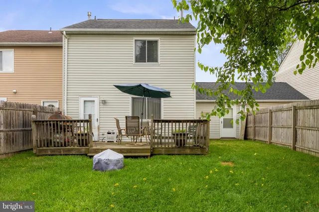a view of a yard with a small cabin and wooden fence