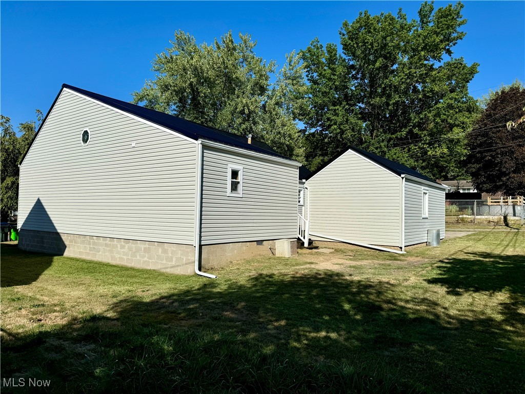 View of home's exterior with a yard