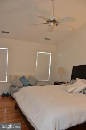 a bedroom with a bed and a night stand