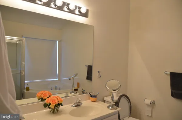 a bathroom with a sink mirror and tub