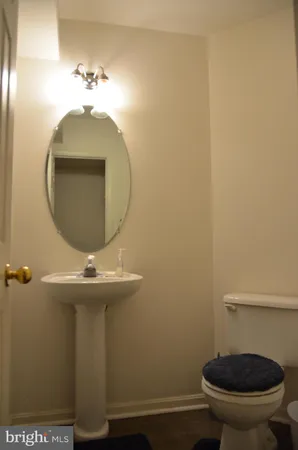 a bathroom with a toilet and a mirror