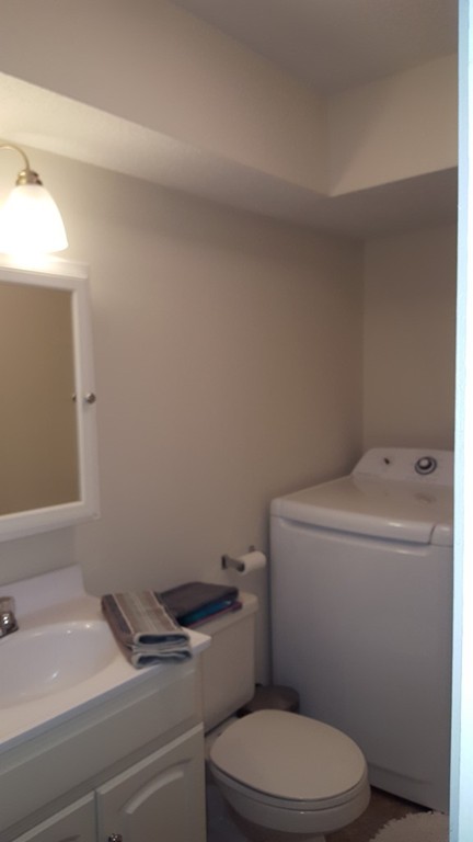 35 Hazen Road, Unit G4 Shirley, MA 01464 - Photo 11 of 15 a white toilet sitting next to a bathroom sink