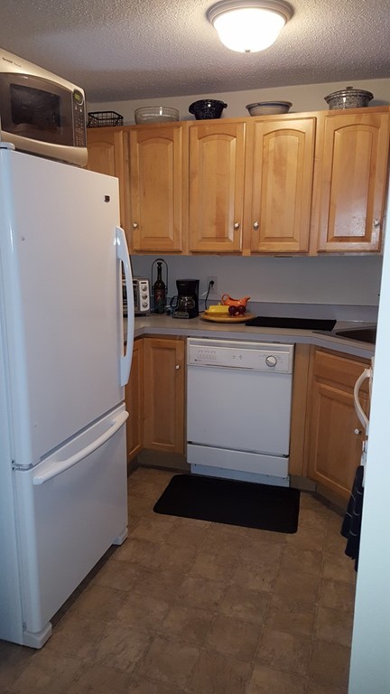 35 Hazen Road, Unit G4 Shirley, MA 01464 - Photo 7 of 15 a white refrigerator freezer sitting in a kitchen