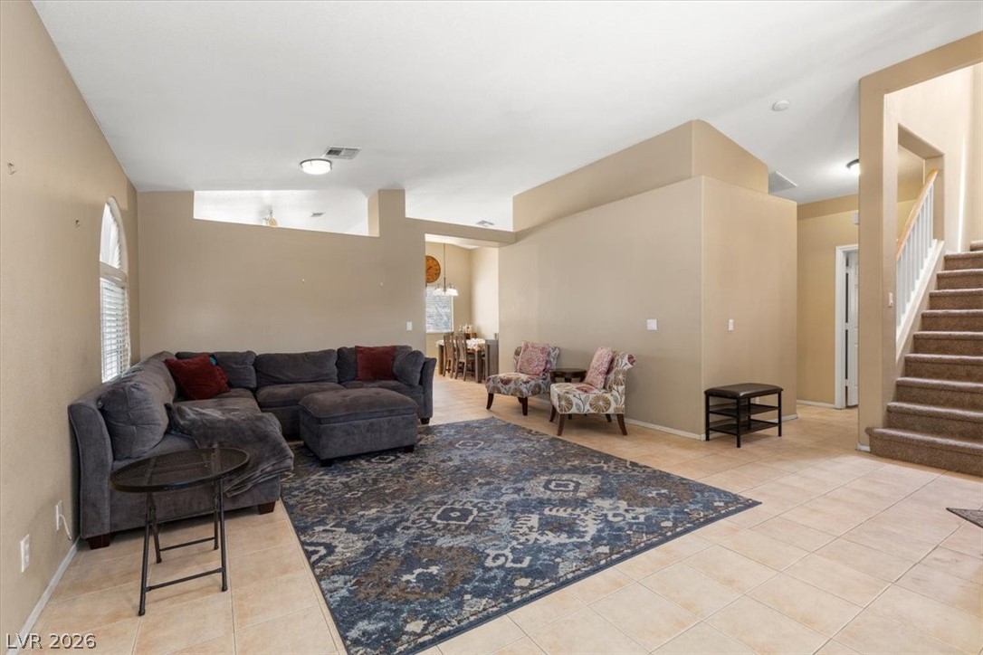 2377 Ramsgate Drive Henderson, NV 89074 - Photo 25 of 25 Natural light illuminates an inviting open floorplan, showcasing elegant tile flooring throughout.
