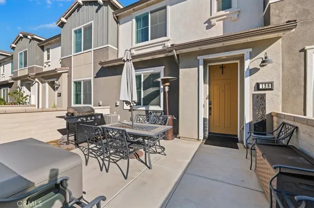 a view of a patio with dining table and chairs