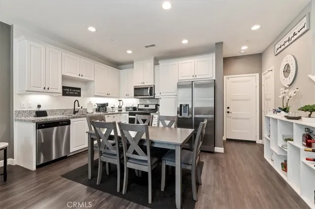 a kitchen with kitchen island granite countertop a center island and a refrigerator