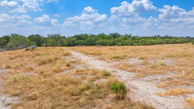 an aerial view of residential houses with outdoor space and city view