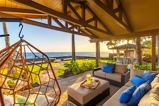 a living room with furniture and floor to ceiling windows