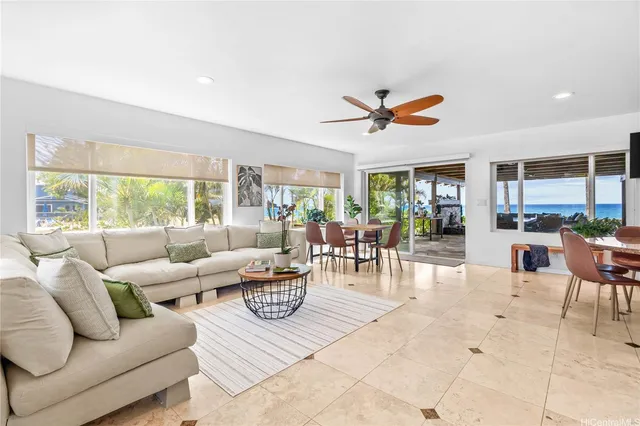 a living room with furniture and a large window with outer view
