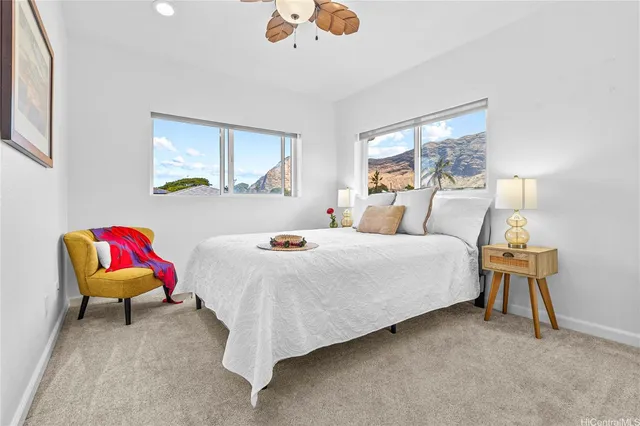 a bedroom with a bed a chandelier and a window