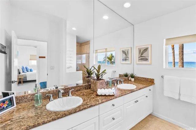a bathroom with double vanity sinks a mirror and a shower
