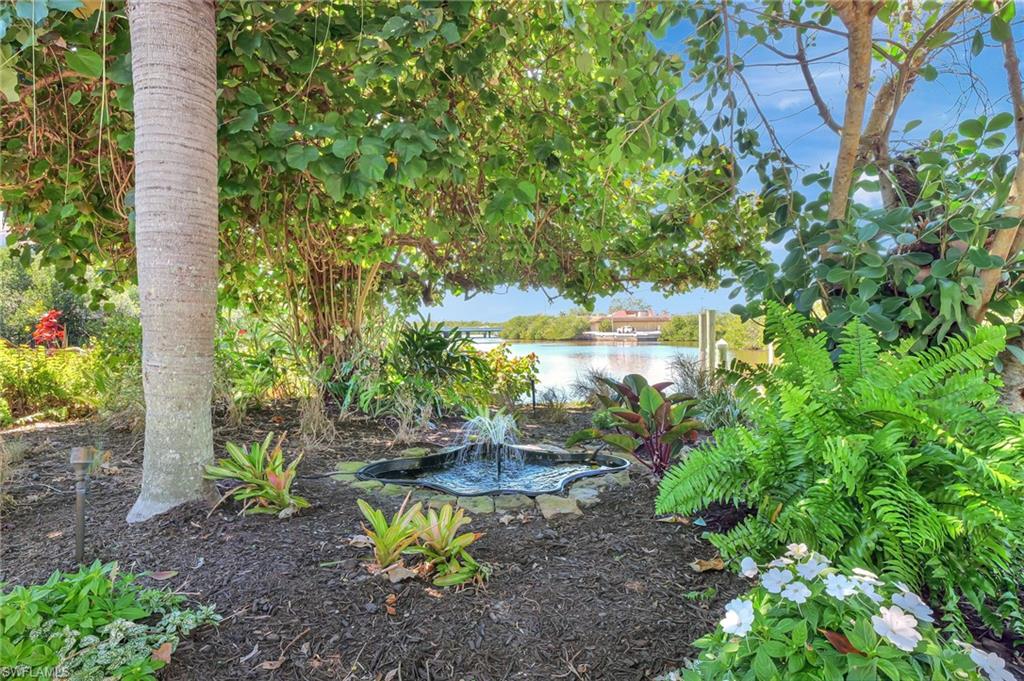 193 Cocohatchee Street Naples, FL 34110 - Photo 40 of 50 Pond with fountain