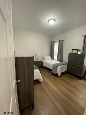 a spacious bedroom with a bed and cabinet