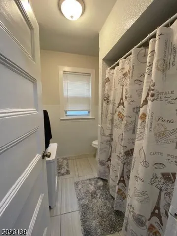 a bathroom with a granite countertop shower and a sink