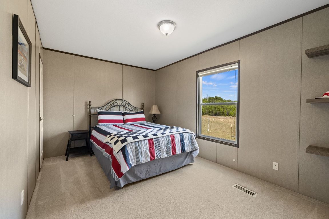 17787 Fm 963 Bertram, TX 78605 - Photo 12 of 40 a bedroom with a bed lamp and window