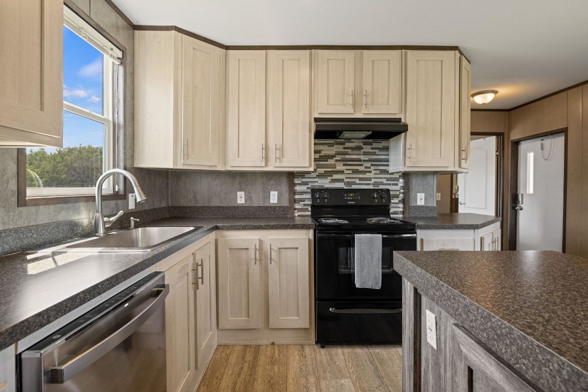 17787 Fm 963 Bertram, TX 78605 - Photo 7 of 40 a kitchen with a sink stove and cabinets