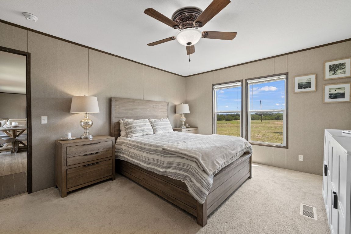 17787 Fm 963 Bertram, TX 78605 - Photo 9 of 40 a spacious bedroom with a large bed and a large window