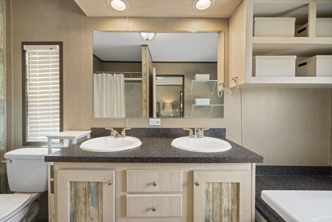 17787 Fm 963 Bertram, TX 78605 - Photo 10 of 40 a bathroom with a granite countertop sink and a mirror