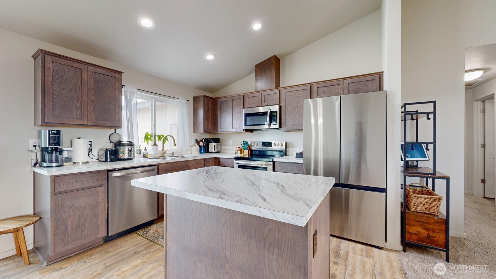 907 East Cascade Street Othello, WA 99344 - Photo 7 of 27 a kitchen with granite countertop a refrigerator a sink a stove a microwave and cabinets