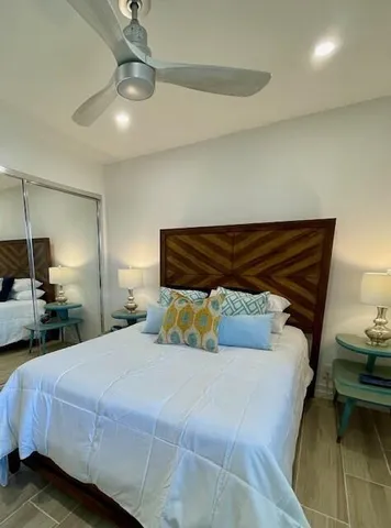 a living room with furniture and a painting on the wall