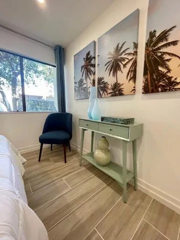 a bathroom with a granite countertop sink mirror toilet and bathtub