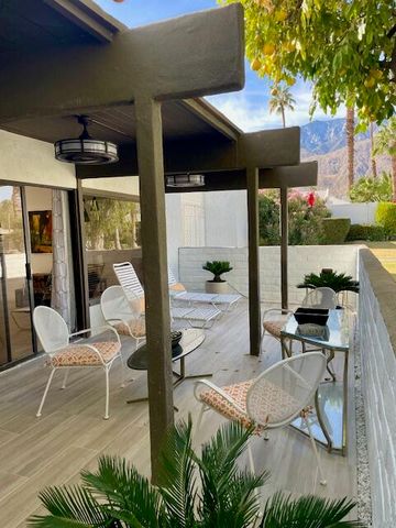 a view of a yard with plants and trees