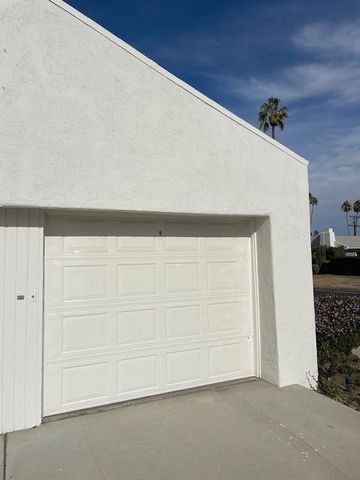 a view of a patio with a table chairs and a fire pit